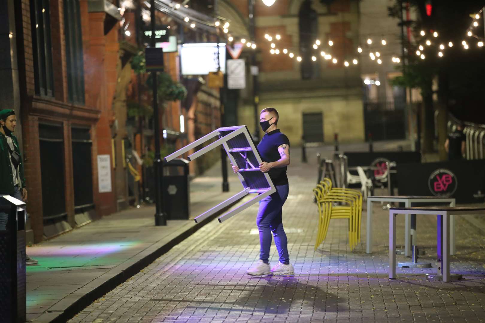 Staff clearing away tables for the evening in Manchester (Danny Lawson/PA)