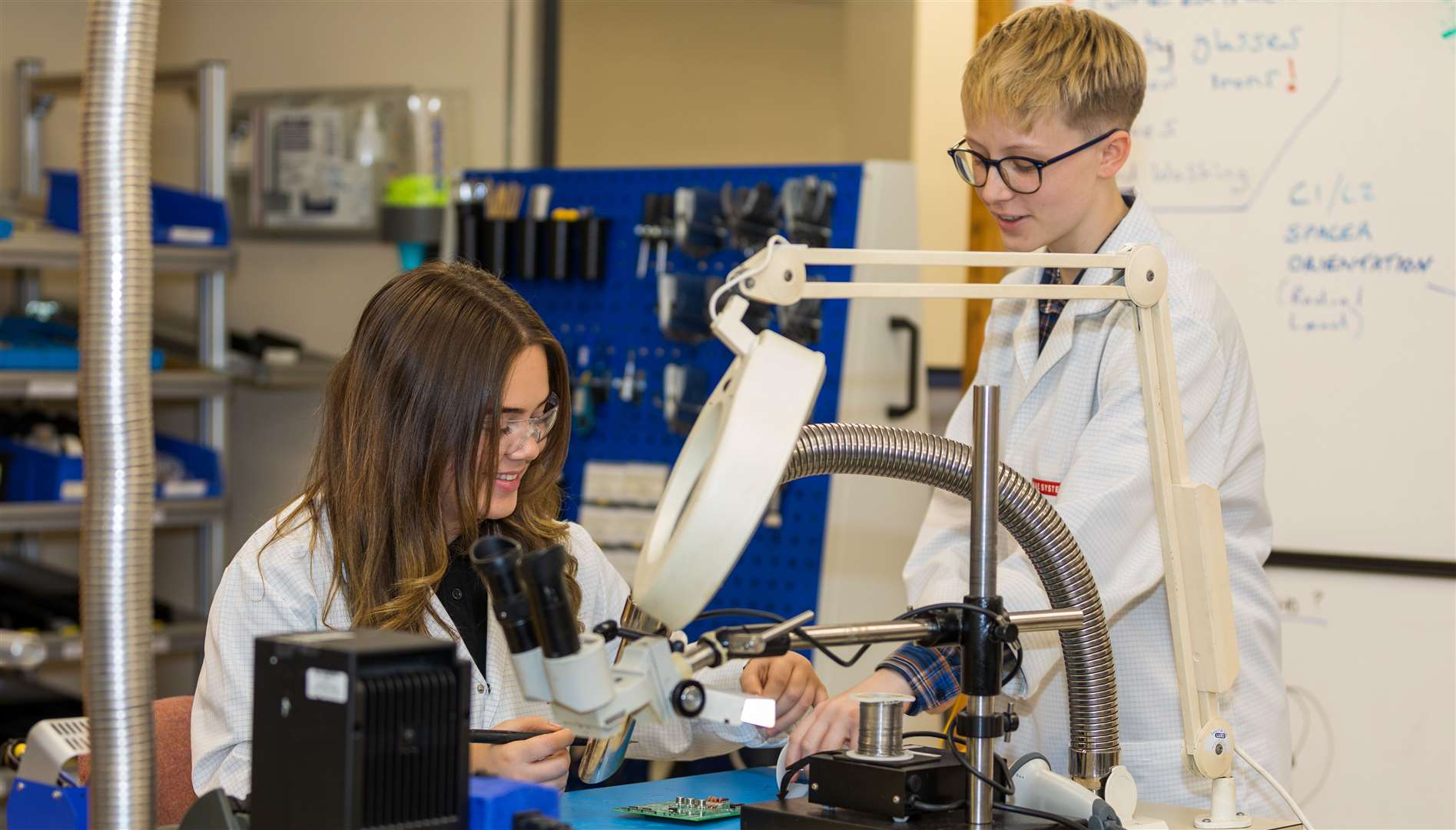 Technical Apprentices Anais Kempster and Roxanne Hector, soldering a circuit board. BAE Systems has technical, finance, and software engineering apprenticeships available this year.