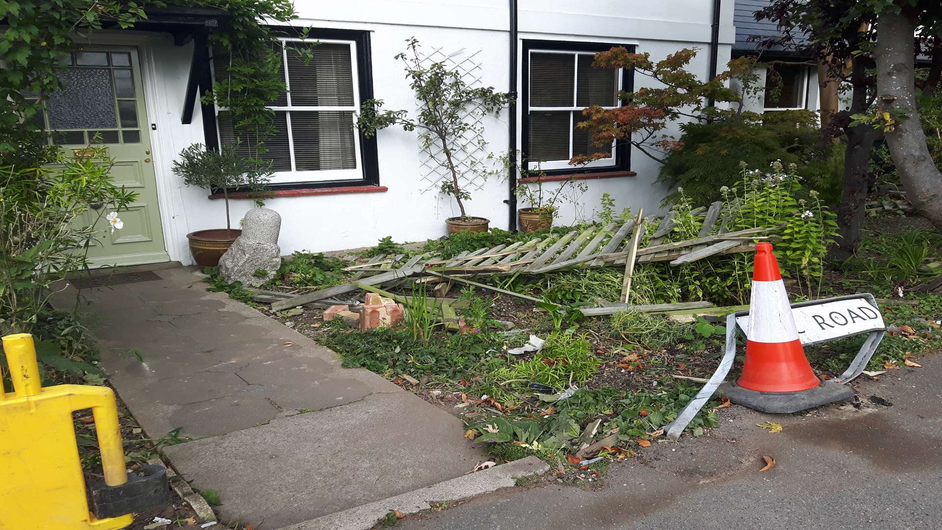 Fence panels are strewn across one front garden