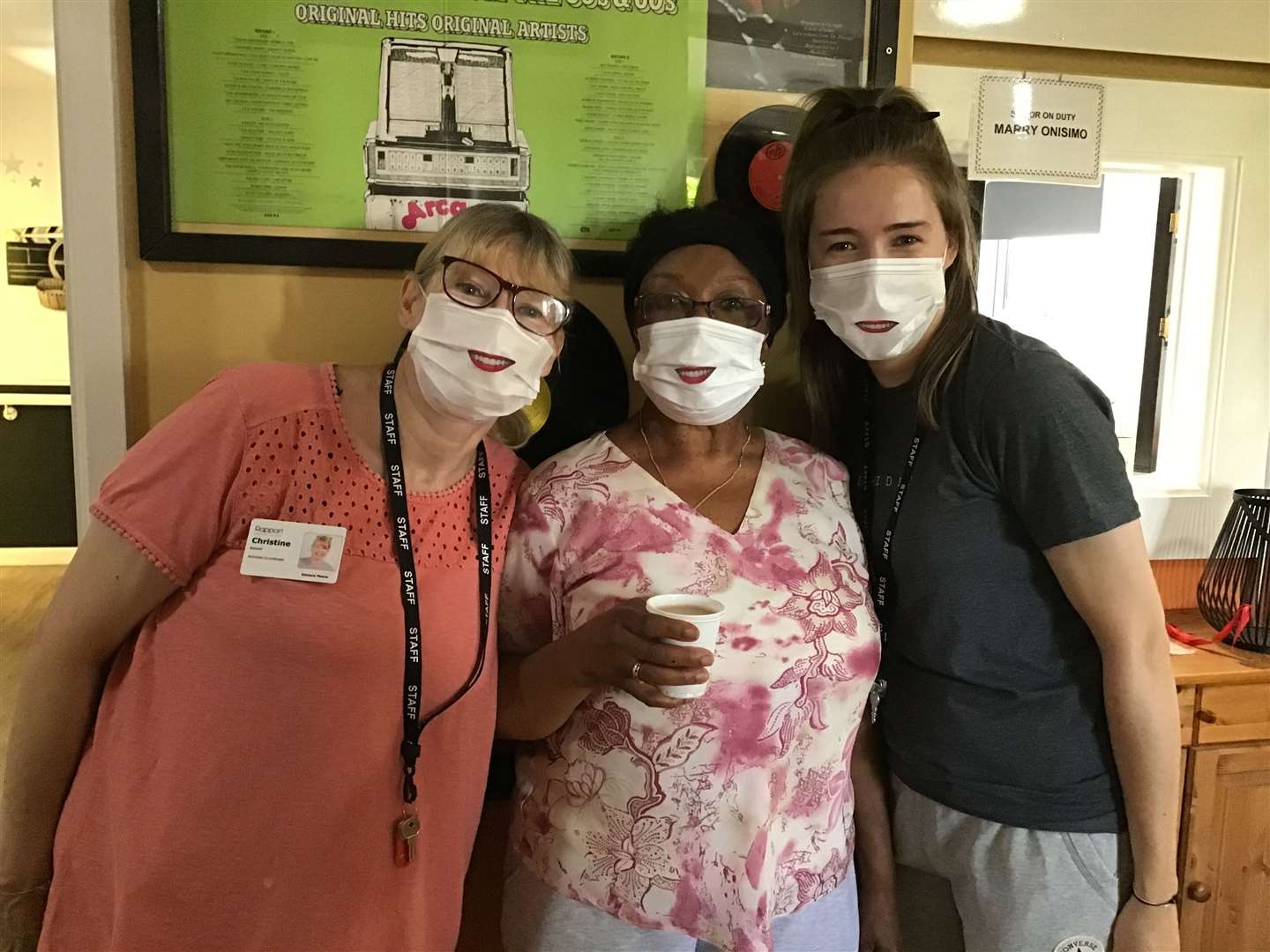 Christine Boswell, Rosaline Baker and Emma Alvis pose with their 'smiley' face masks