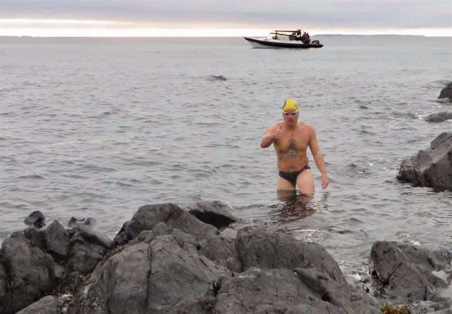 Jordon Leckey at the end of his record breaking swim (Infinity Channel Swimming/PA)