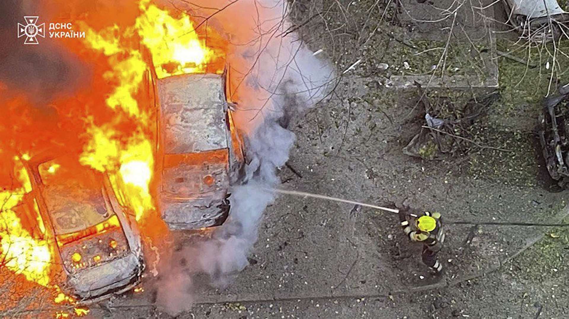 Emergency services personnel work to extinguish a fire following a Russian rocket attack on Ukraine (Ukrainian Emergency Service via AP)