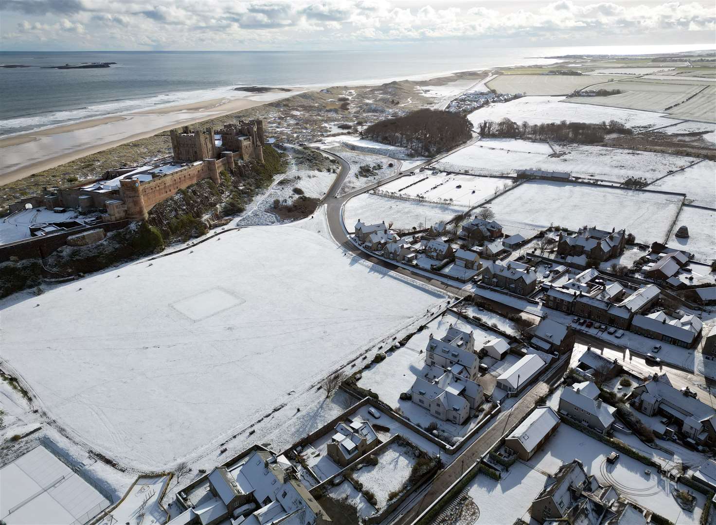 Bamburgh Castle in Northumberland surrounded by snow (Owen Humphreys/PA)