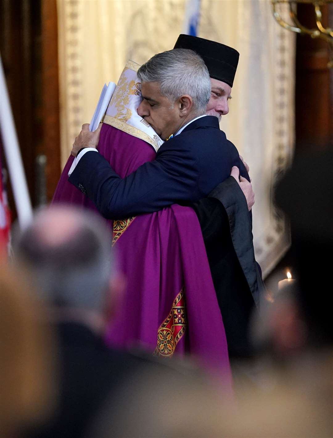 London mayor Sadiq Khan is embraced by Bishop Kenneth Nowakowski following his speech (Yui Mok/PA)