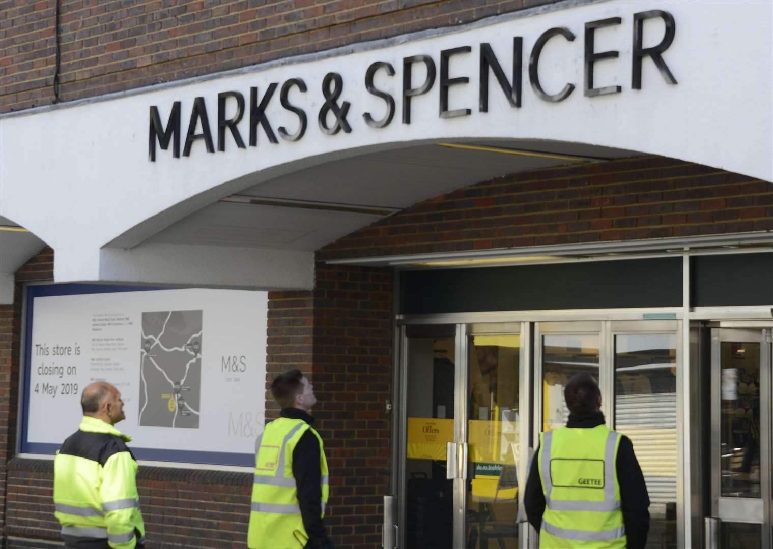Workmen preparing to take down the sign as Marks and Spencer closes its doors in Ashford