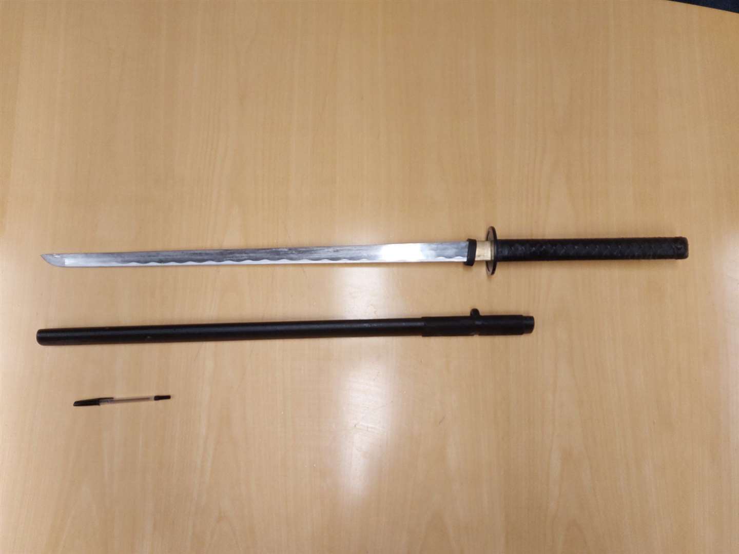 Police seized this sword after stopping a car in Tenterden, with a pen for scale. Photo: Kent Police