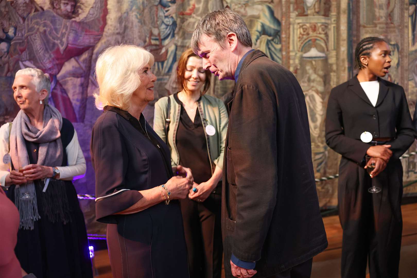 Camilla speaks to Sir Ian Rankin during a reception with authors, actors and lovers of literature attending the Queen’s Reading Room Literary Festival at Hampton Court Palace in June (PA)