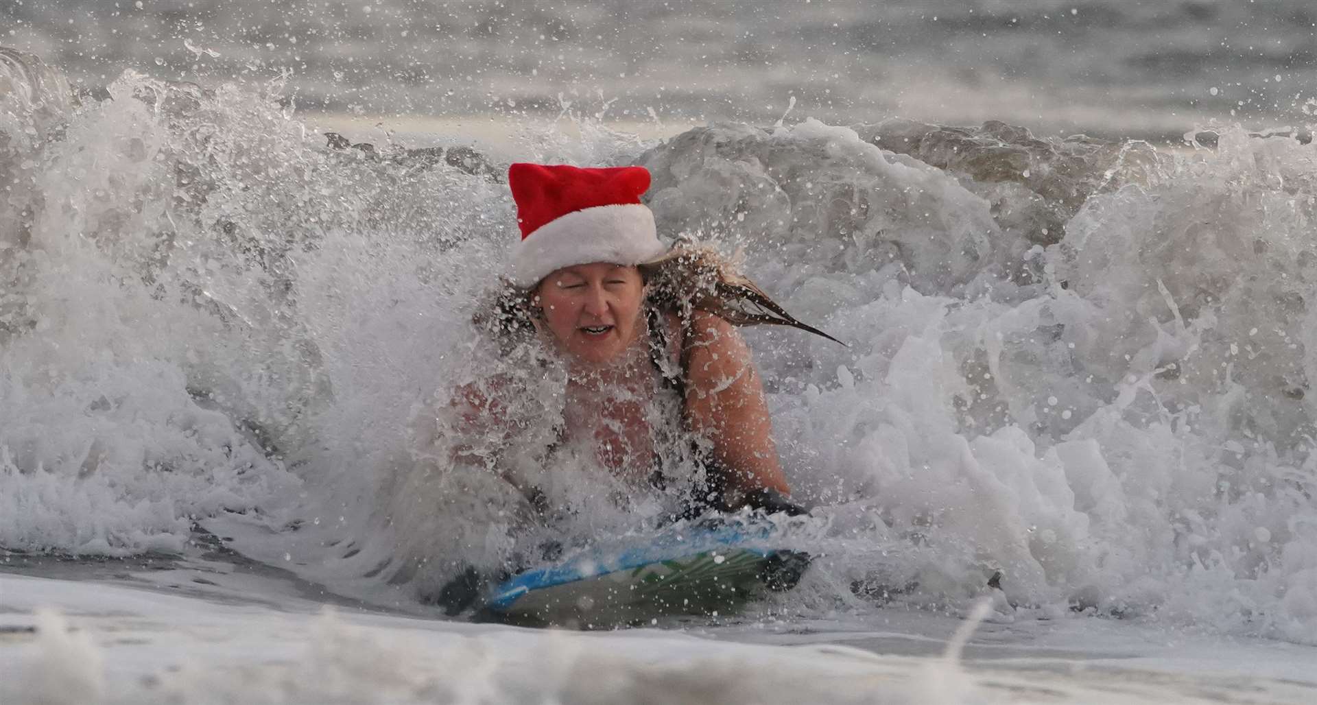 Others were braver and took to the North Sea for some bodyboarding (Owen Humphreys/PA)