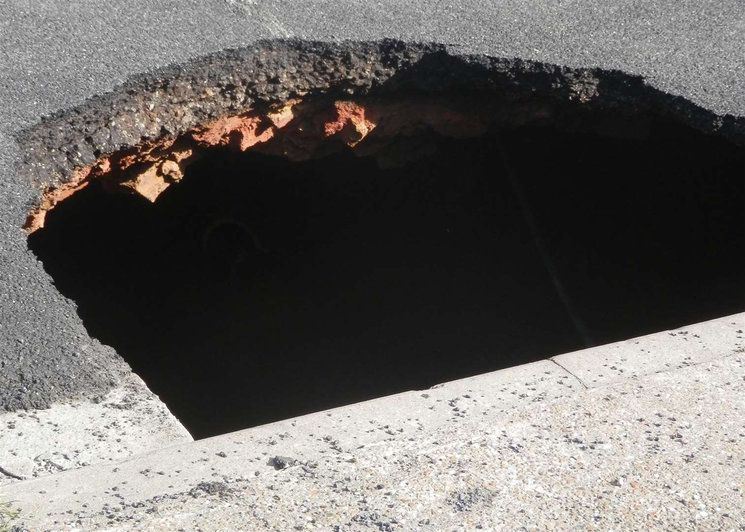 A similar, large hole appeared in the road in Elaine Avenue, Stood in 2014. Picture: Nicole Xhepa