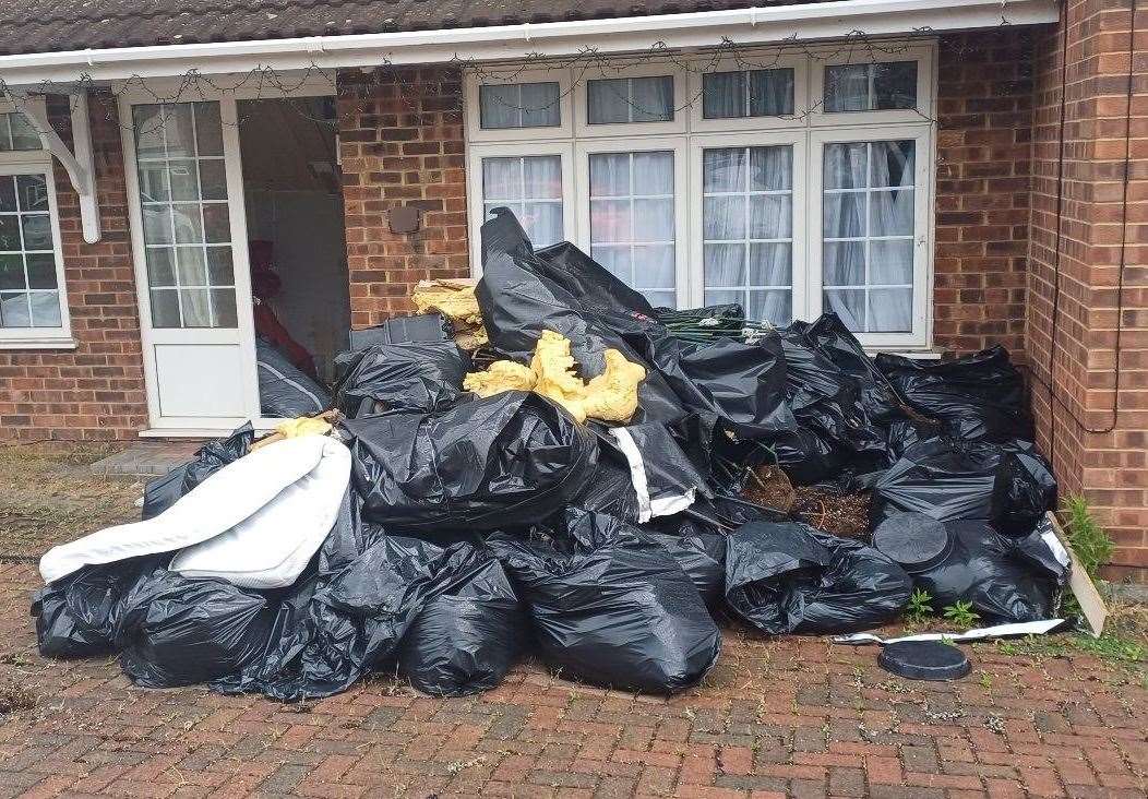 A large mound of rubbish remains on the front drive of the property