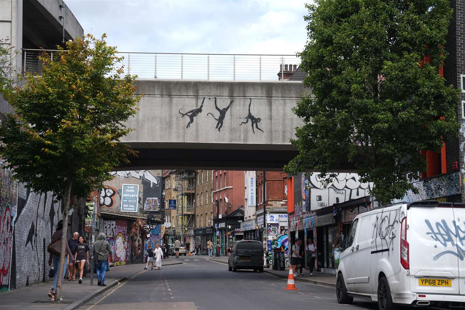 The three monkeys on a bridge in Brick Lane, east London (PA)