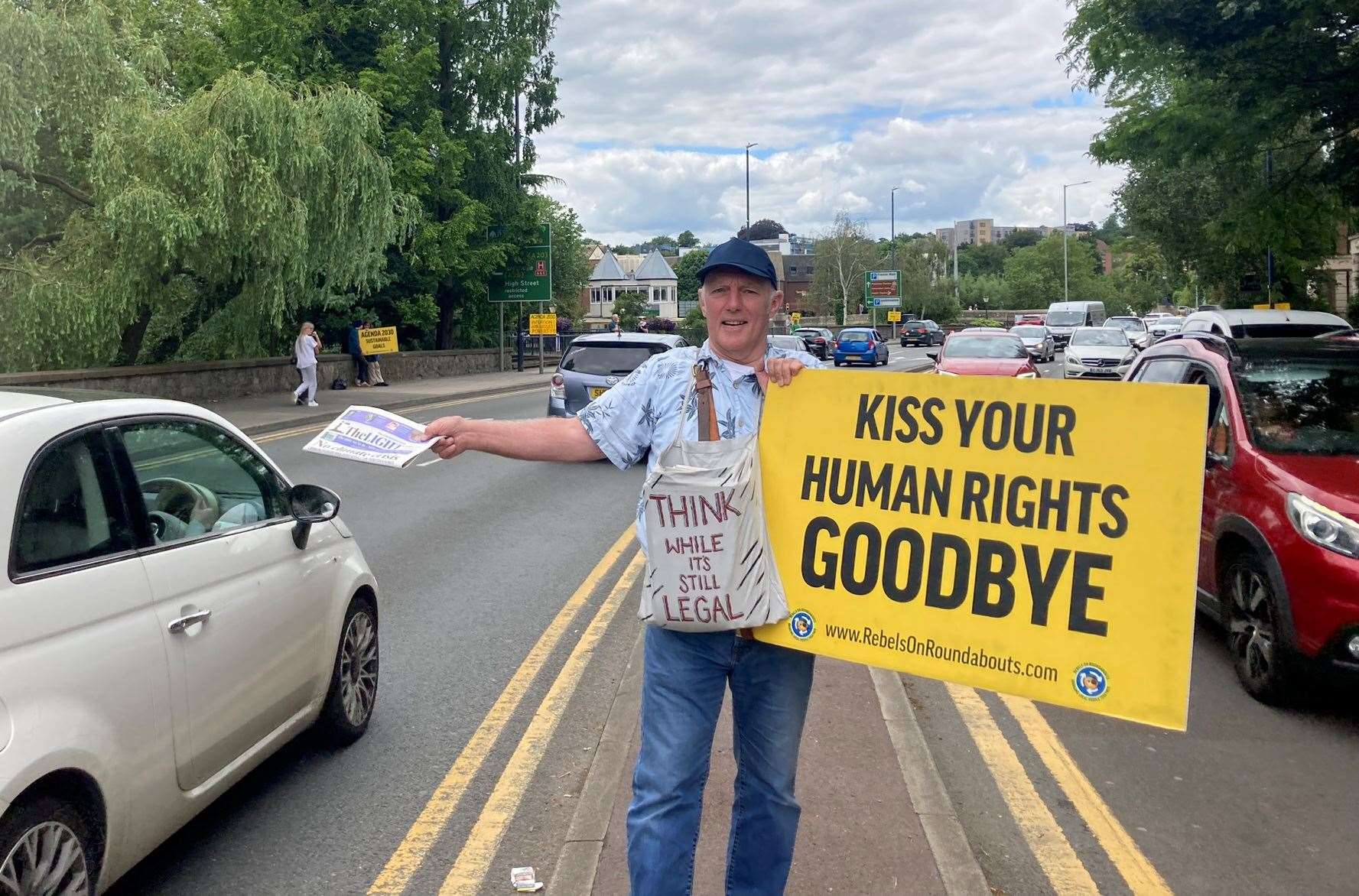 This protester is urging people to “think while it’s still legal”