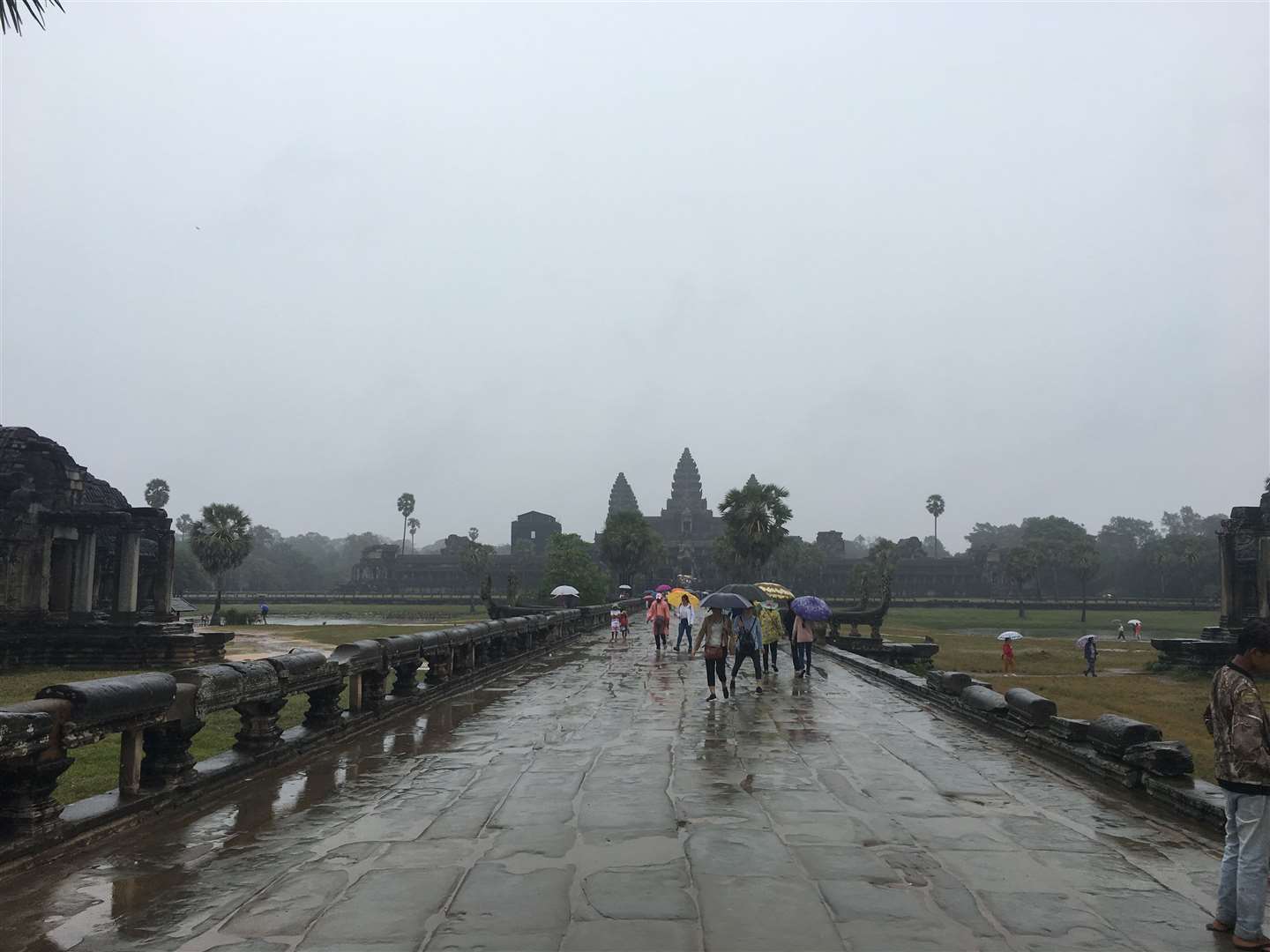 Even in the rain, the temples at Angkor Wat attract thousands of visitors a day. Picture: Matt Leclere
