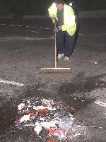 Police clear the debris after the crash