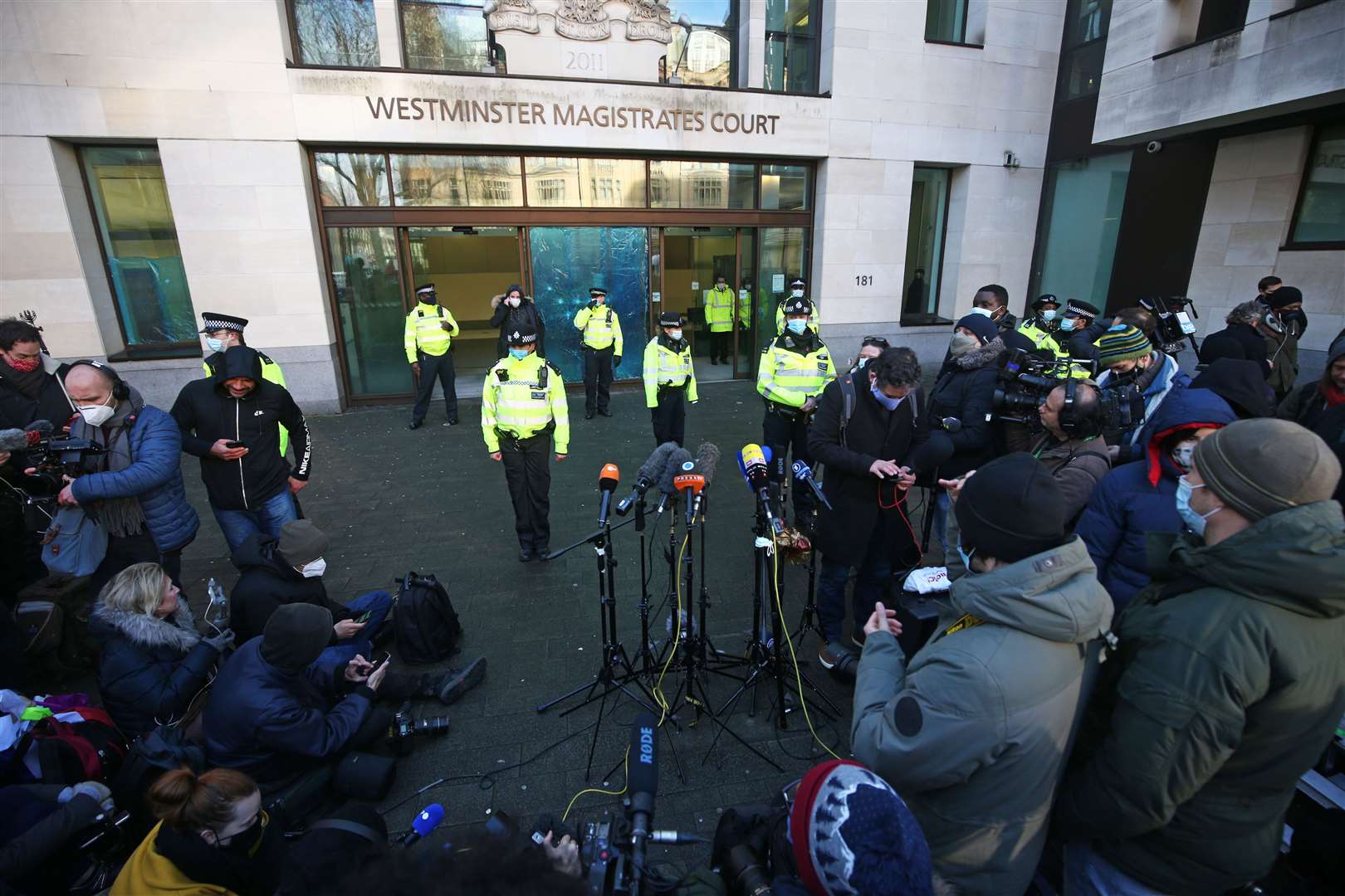 Police officers and members of the media outside Westminster Magistrates’ Court (Yui Mok/PA)