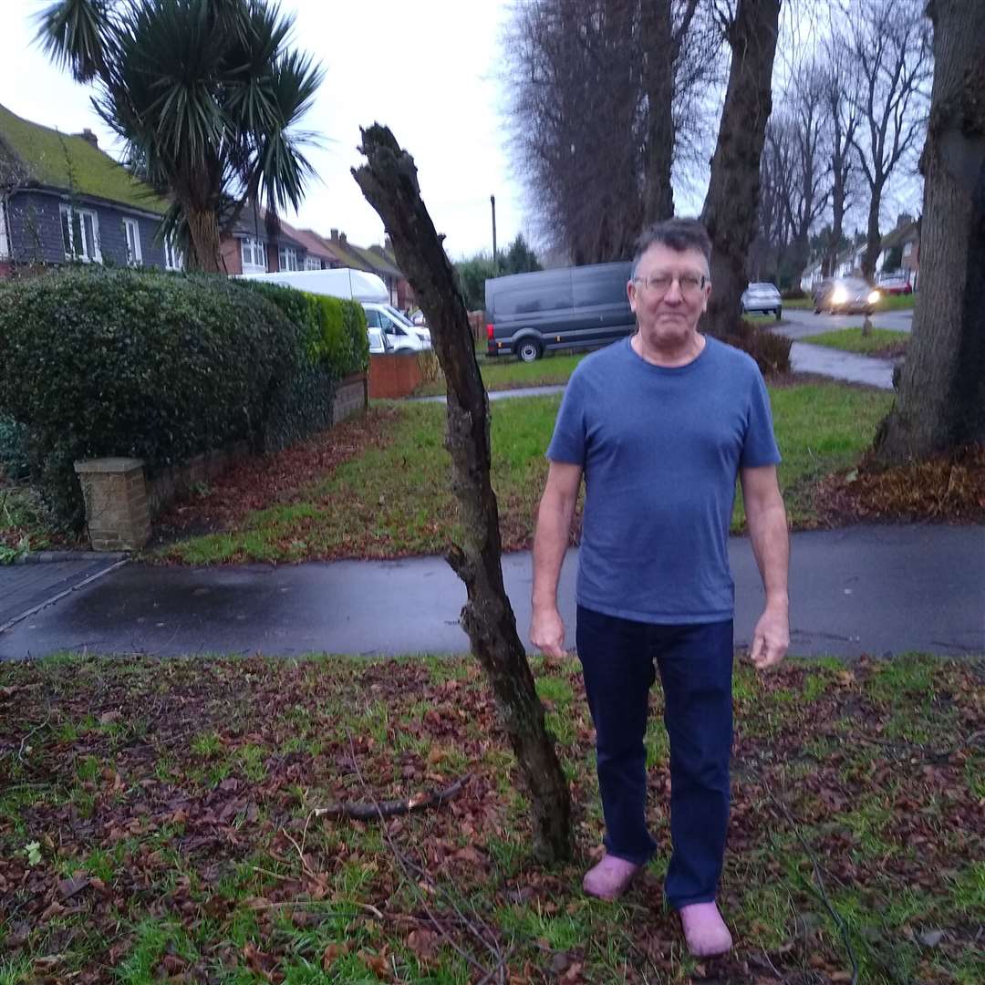 David Burrows by the fallen branch, which is taller than him