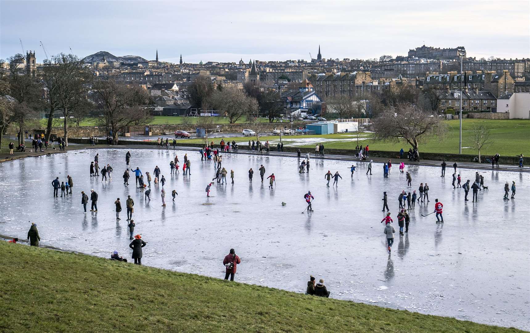 People on the frozen pond in Inverleith Park, Edinburgh (Jane Barlow/PA)