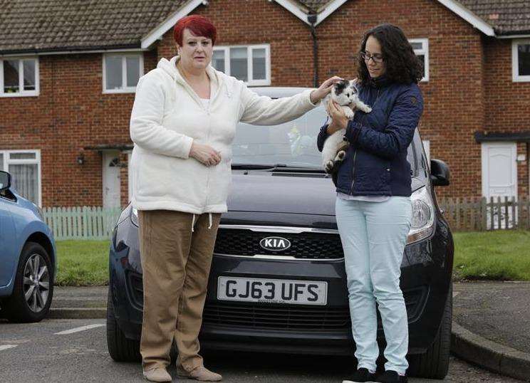 From left, Jane Butcher and Filipa Cunha with Timmy the 3-year-old Portuguese tom cat