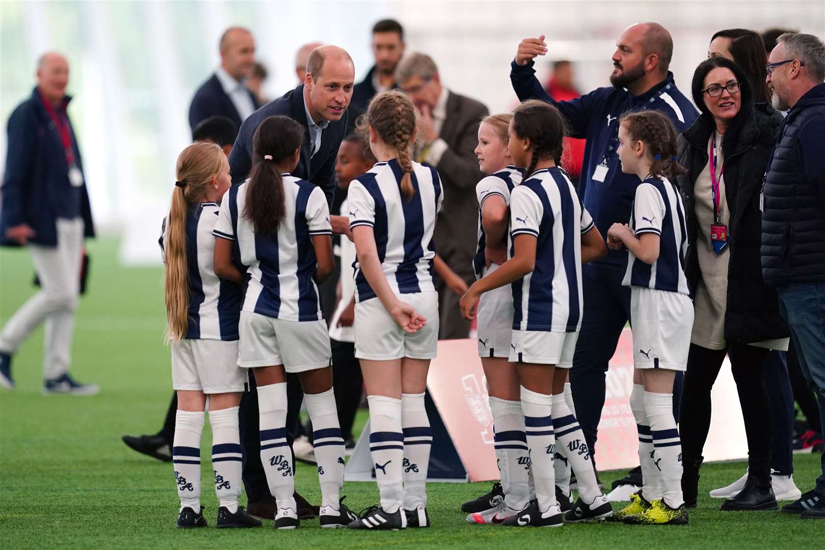 The Prince of Wales talking to children at St George’s Park in Burton upon Trent to mark its 10th anniversary as the home of English football (David Davies/PA)