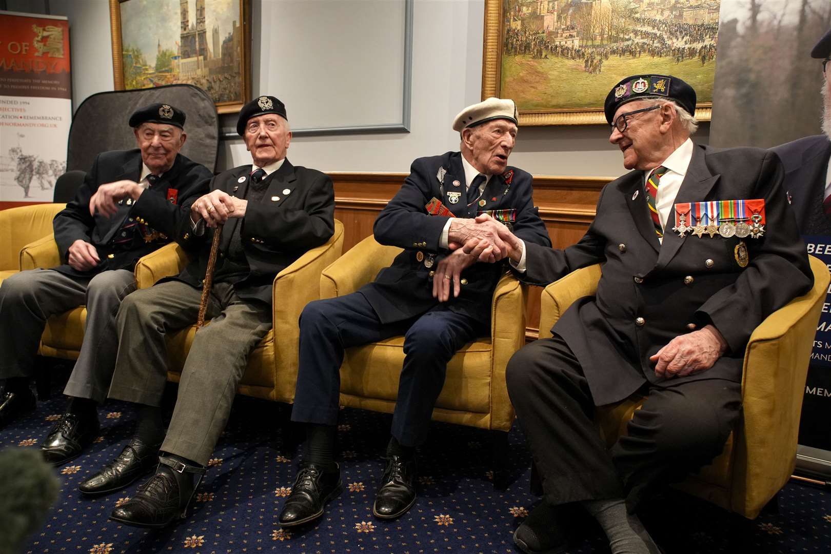 D-Day veterans Alec Penstone (second right), 98, who served with the Royal Navy, shakes hands with Ken Hay (right), 98, ambassador for the British Normandy Memorial who served with the 4th Dorset Regiment (Gareth Fuller/PA)