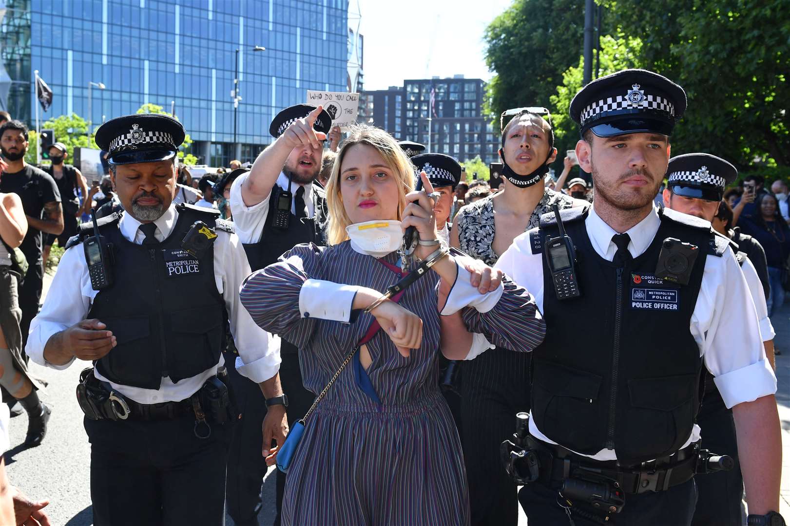 A woman is led away by police during a Black Lives Matter protest outside the US embassy in London (Dominic Lipinski/PA)