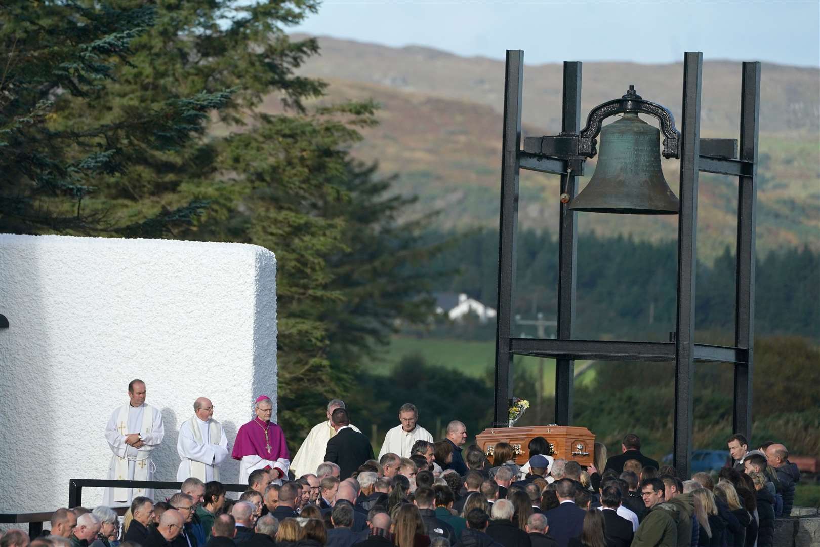 Mourners gather as the coffin of Hugh Kelly arrives at St Michael’s Church, in Creeslough (Brian Lawless/PA)