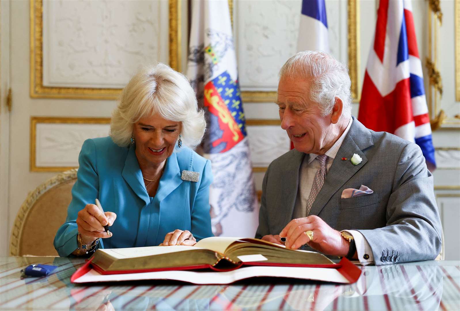 Charles and Camilla signed the guestbook in Bordeaux (Hannah McKay/PA)