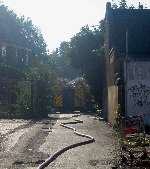 A fire engine in the access road beside the hall