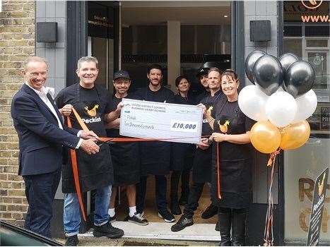 Staff at Peckish Rotisserie Chicken presented their cheque by council leader Trevor Bartlett.Picture: Dover District Council