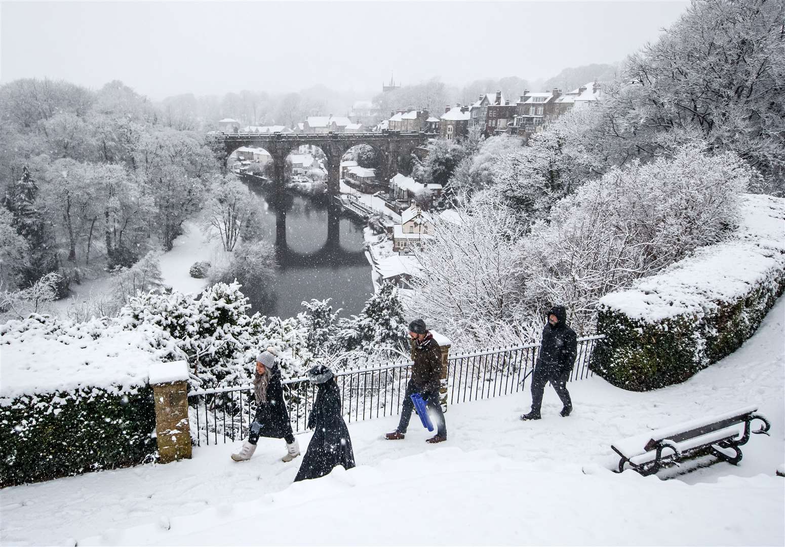 People walk near Knaresborough Viaduct in Knaresborough, North Yorkshire after snow fell overnight (Danny Lawson/PA)