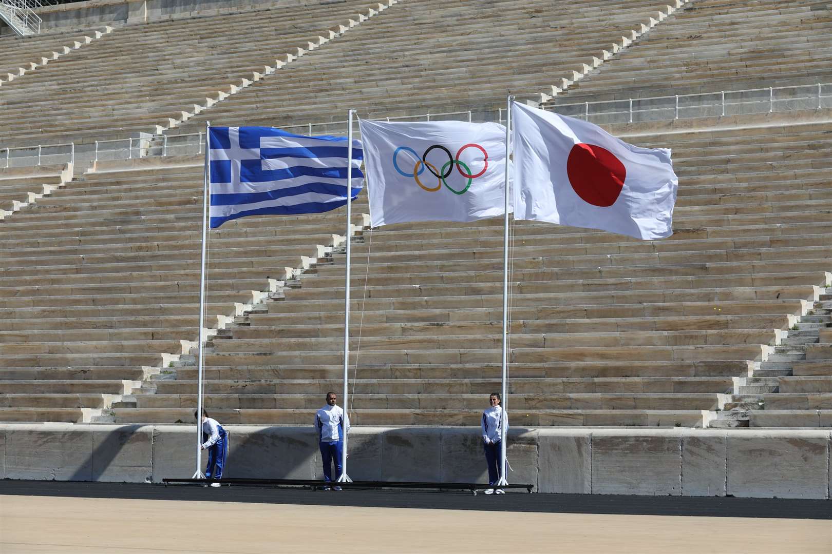 The official Olympic flame handover from Greece to Japan ahead of the torch's journey to Tokyo. Picture: IOC