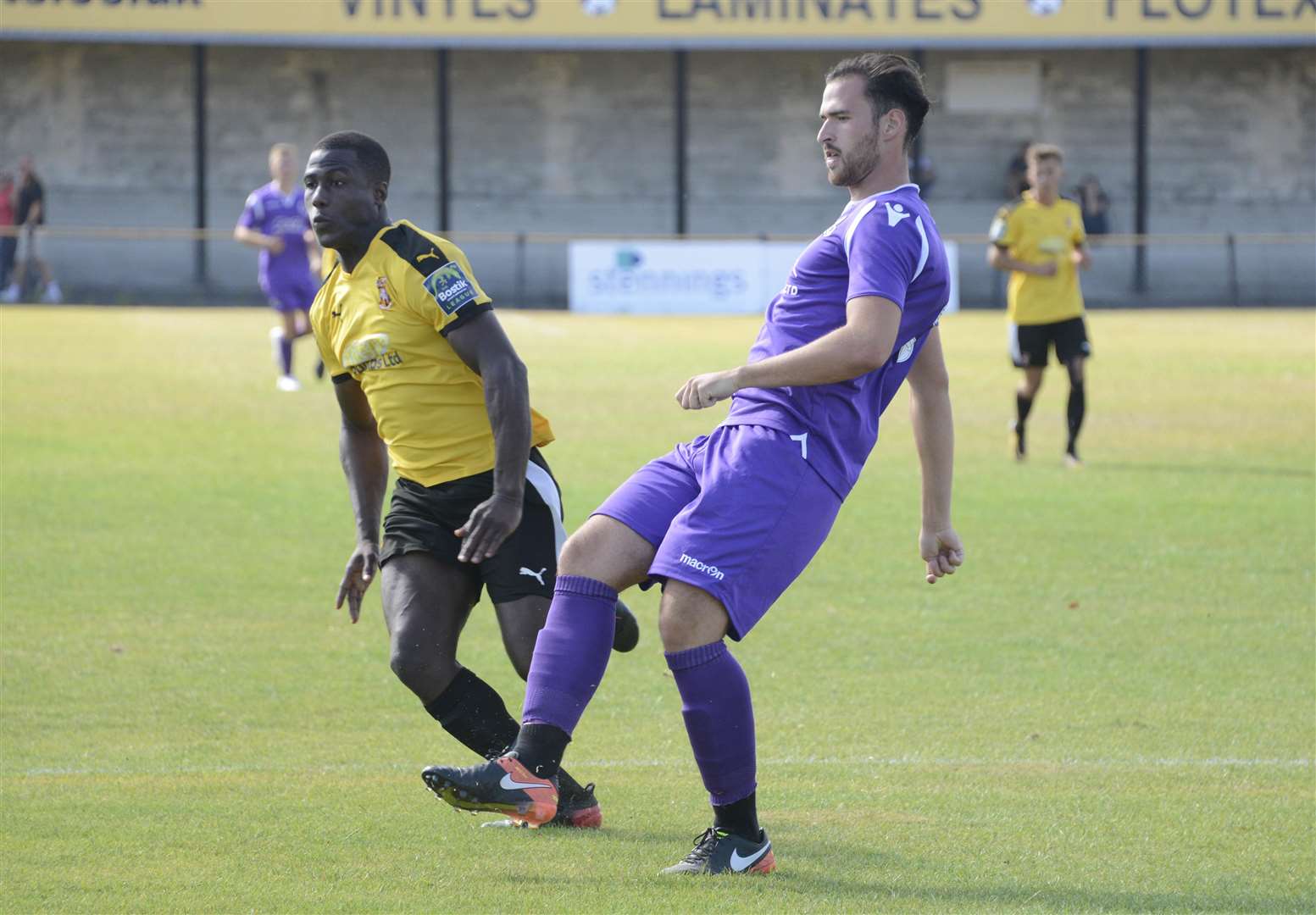 Ronnie Vint plays the ball away from Folkestone's Ade Yusuff Picture: Paul Amos