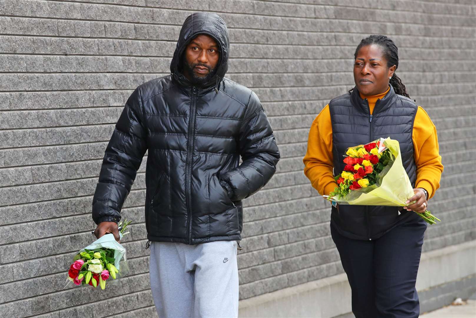 People carry flowers to Croydon Custody Centre in south London (Aaron Chown/PA)