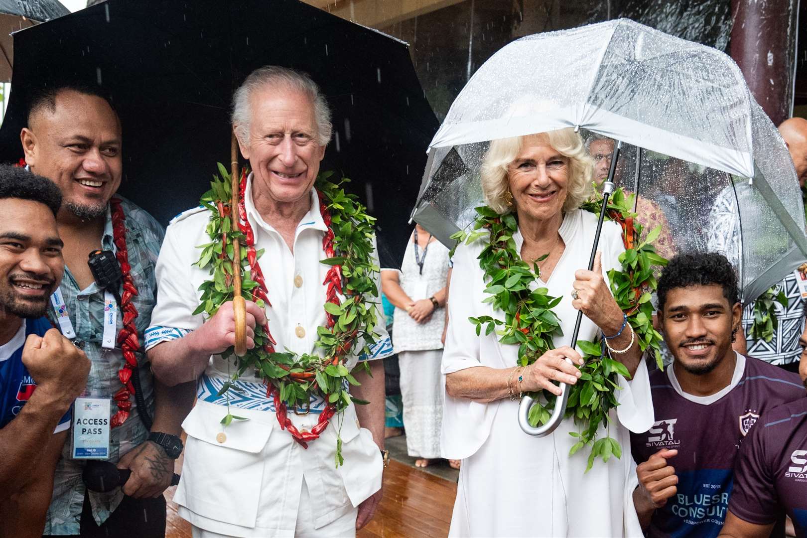 Charles and Camilla may have hoped to escape the cold and rain of a UK autumn with a tour to Australia and Samoa in October, but they still needed umbrellas when they met members of the Apia rugby team rugby (Aaron Chown/PA)