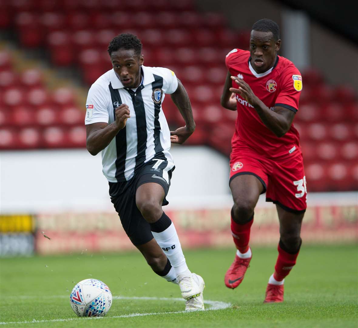 Gillingham forward Brandon Hanlan gets away from Walsall's Isaiah Osbourne Picture: Ady Kerry