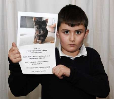 Johnathan Kennedy with the posters he and his friends have put up around Hersden trying to trace his lost puppy Tyke