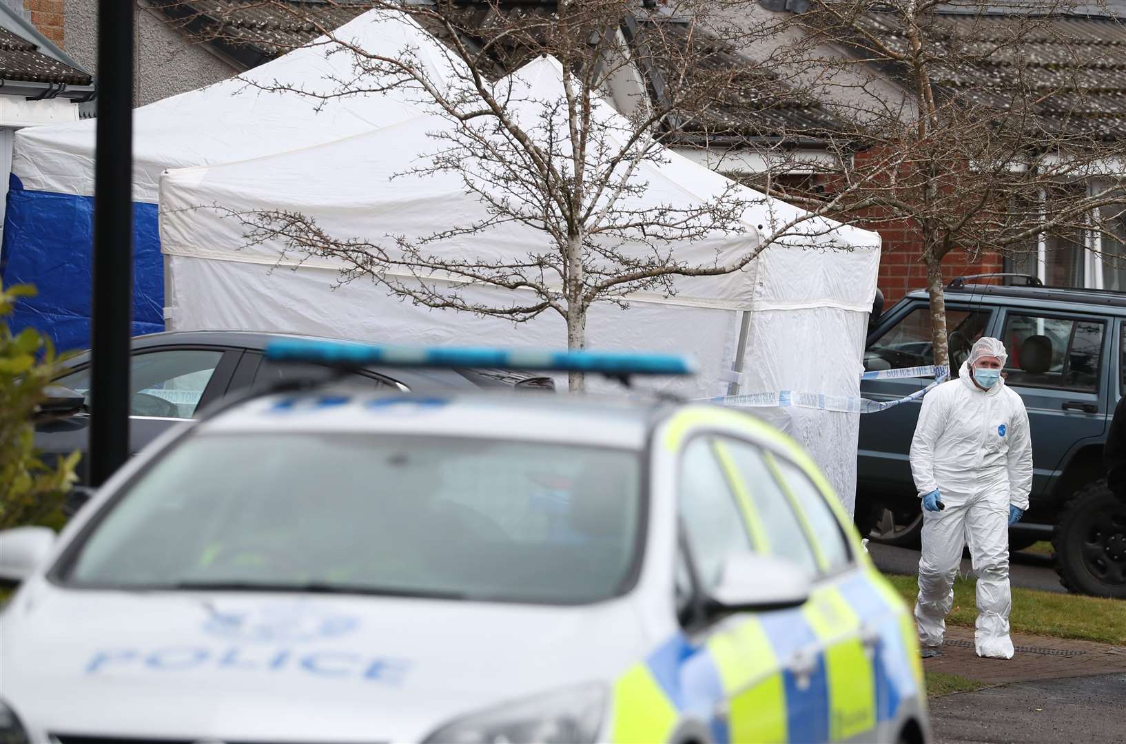 Police forensics officers hunting for evidence outside the house in Dundee (Andrew Milligan/PA)