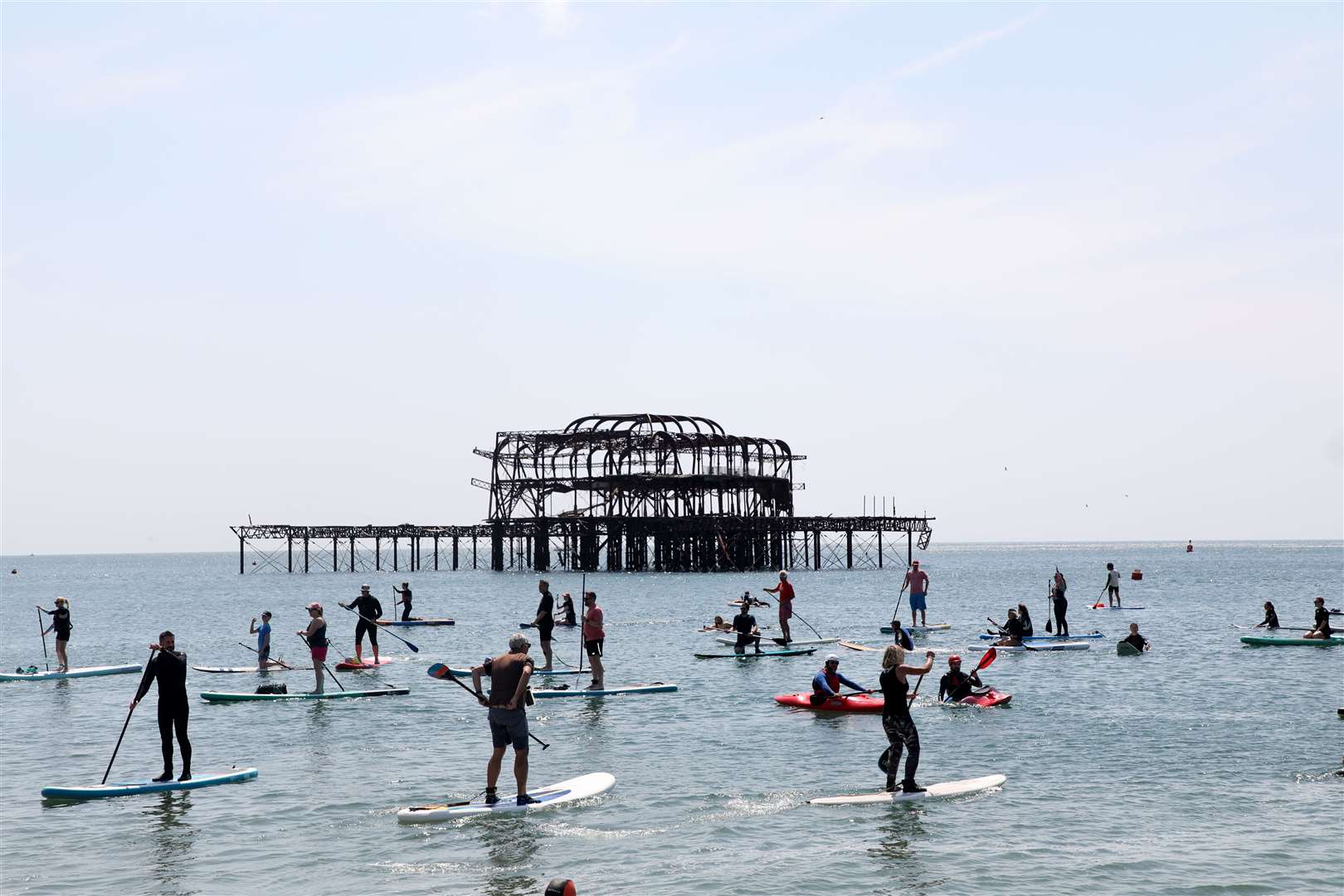 Protesters at a paddle-out protest in Brighton (PA)