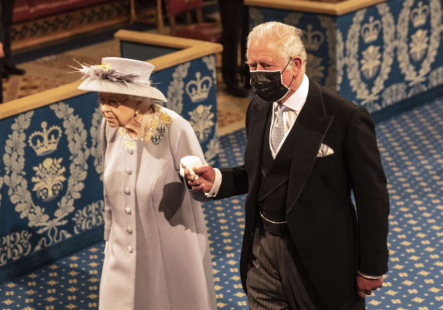 The Queen, accompanied by the Prince of Wales, proceeds through the Royal Gallery before delivering the Queen’s Speech (Richard Pohle/The Times/PA)