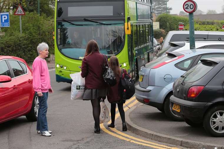 The youngsters are shielded against traffic on the busy road