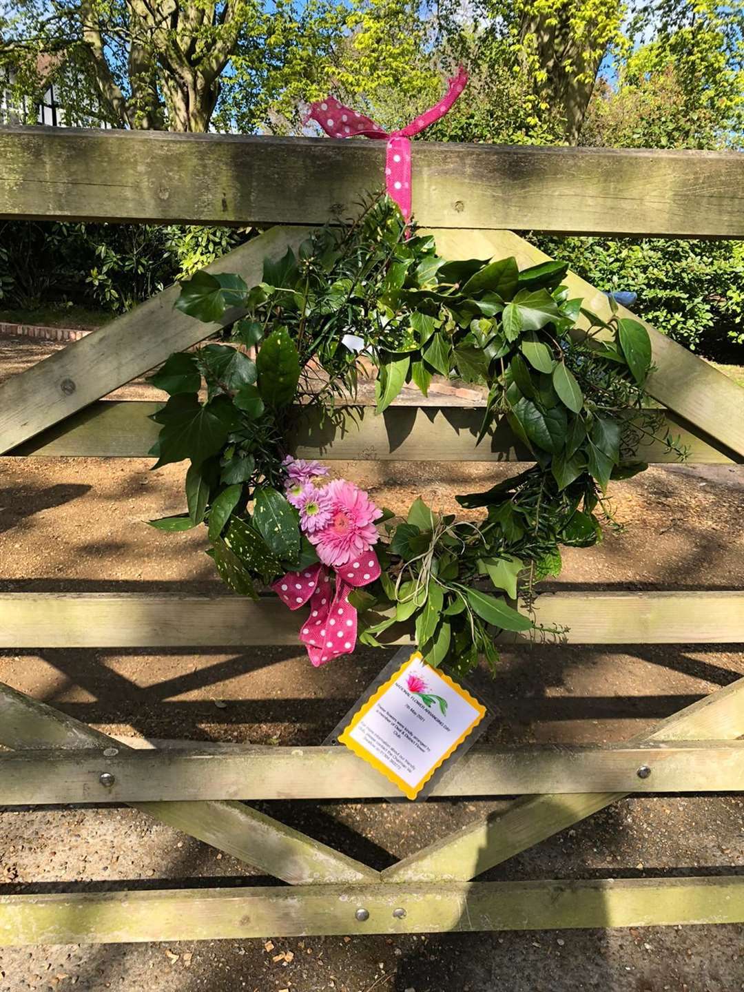 Pink flowers and ribbon contrasted beautifully against the waxy leaves of this wreath