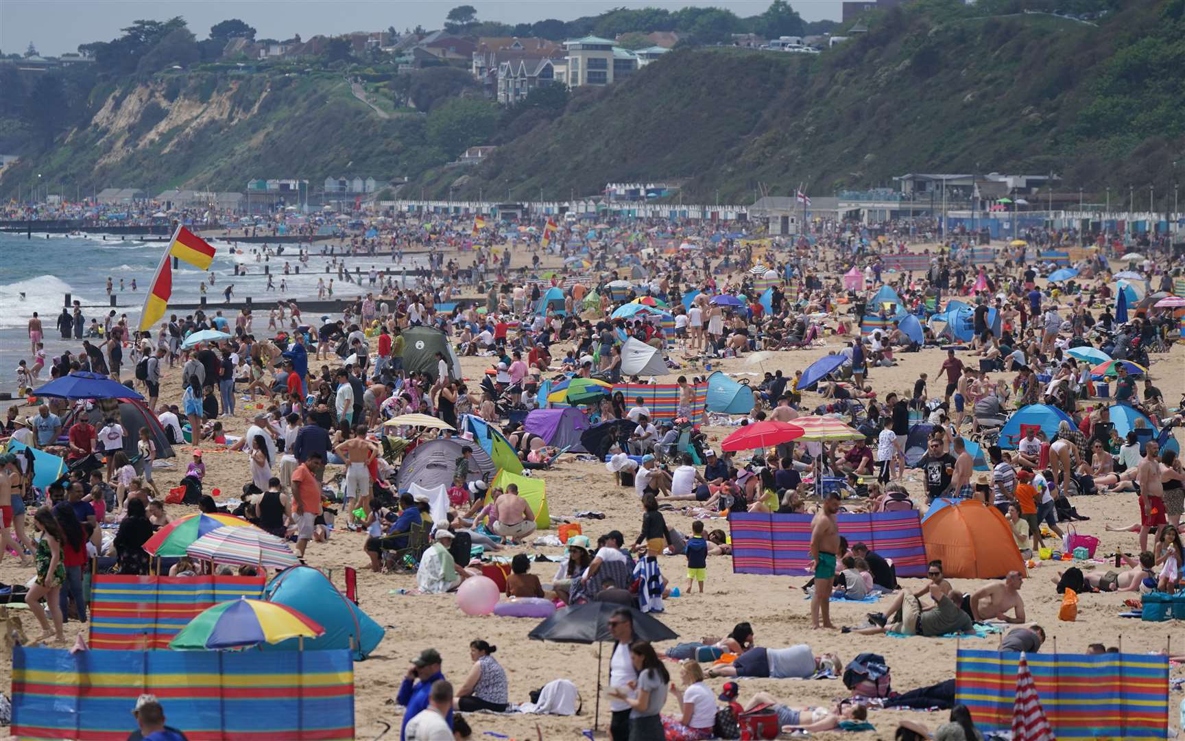 People enjoy the warm weather on Bournemouth beach (Andrew Matthews/PA)