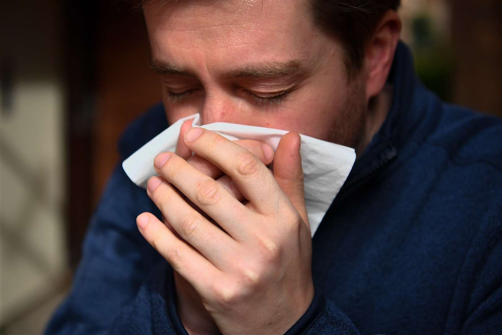 The virus is spread through cough or sneeze droplets, so make sure you catch them in a tissue you then throw away (Ben Birchall/PA)