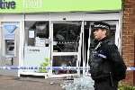 A policeman stands guard outside the store