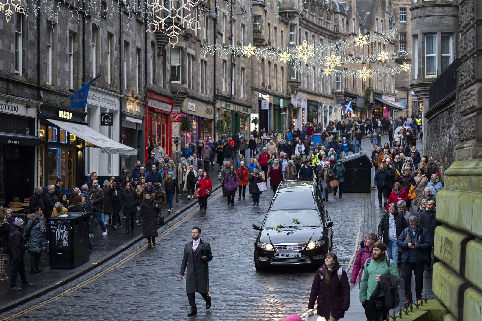 People line the streets as Janey Godley’s hearse travels through Edinburgh (Jane Barlow/PA)