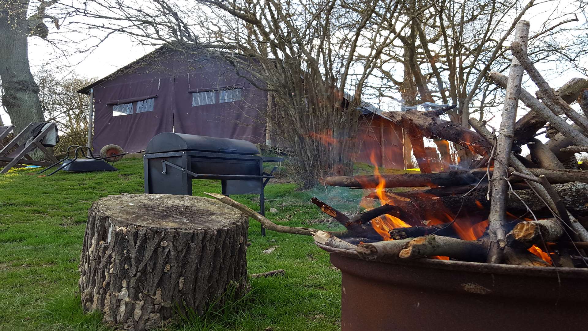 Outside each tent is a space for a camp fire, a barbecue, and deck chairs