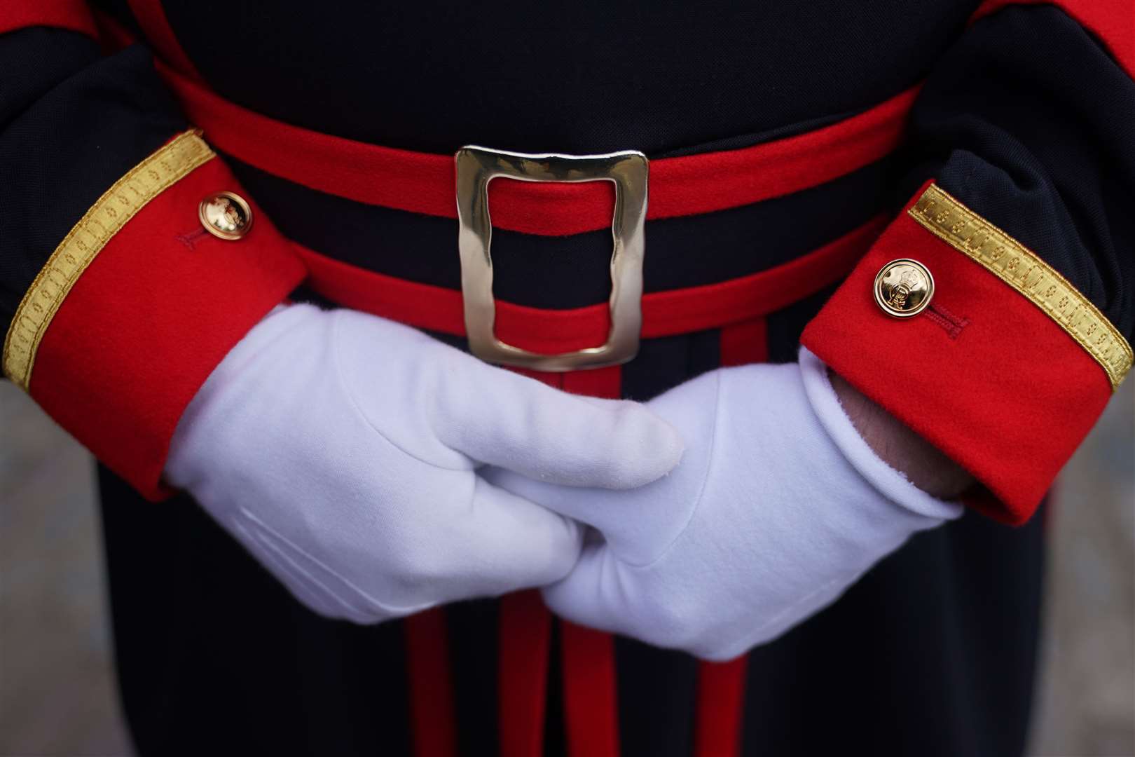 A Yeoman Warder displays the King’s cypher on their cufflinks (Yui Mok/PA)