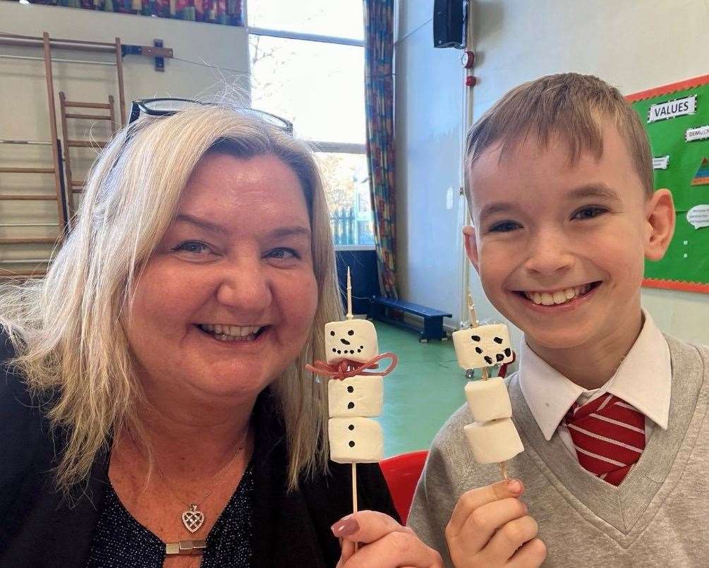 Tina Lovey, who has been given an OBE in the King's Birthday Honours, with a Walderslade Primary student