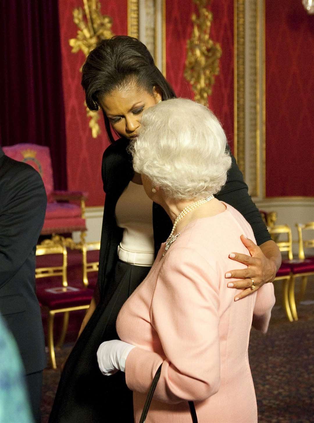 Michelle Obama puts her arm around the Queen (PA/Daniel Hambury)