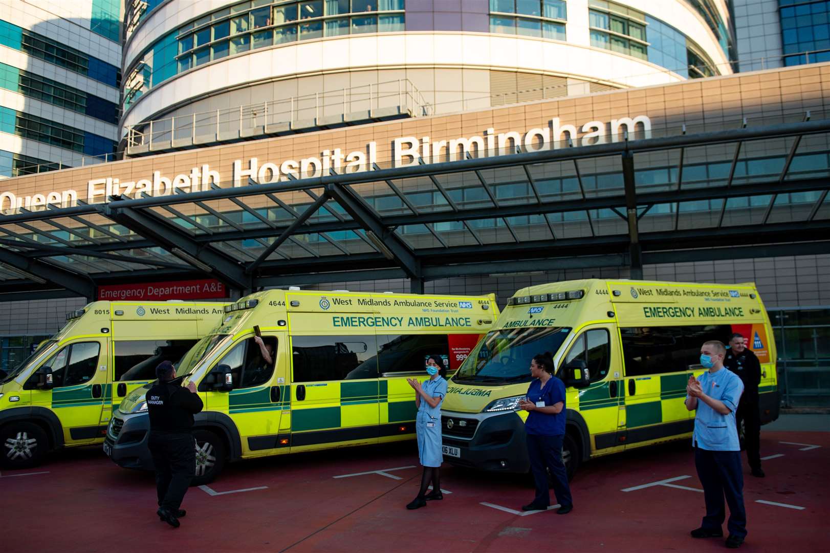 NHS staff outside the Queen Elizabeth Hospital, Birmingham, during a clap for carers (Jacob King/PA)